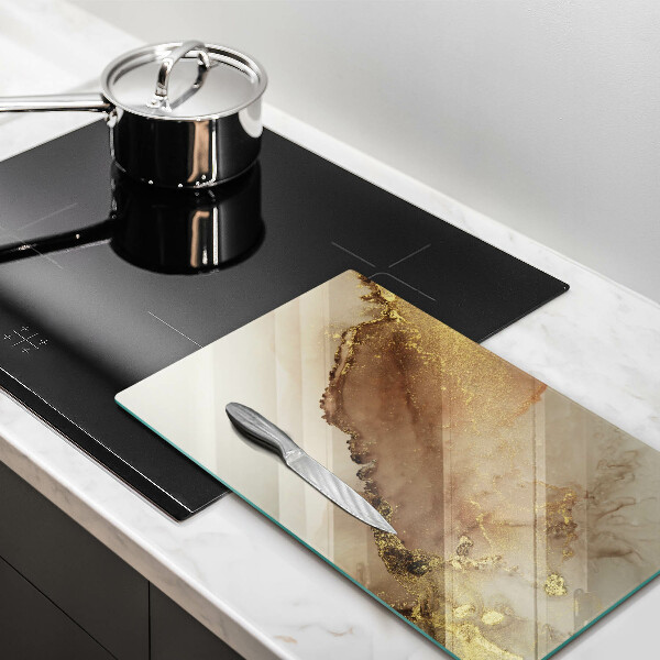 Glasskärbräda med abstrakt guldmönster