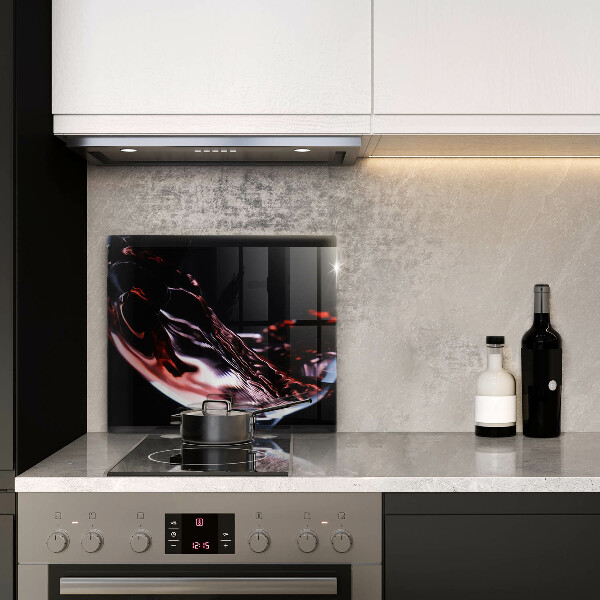 Skärbräda av glas Ett glas rött vin