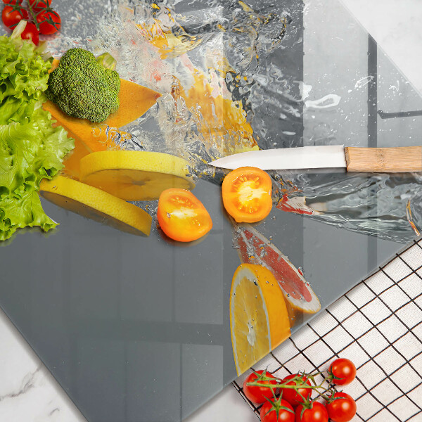 Skärbräda av glas Citroner i vatten