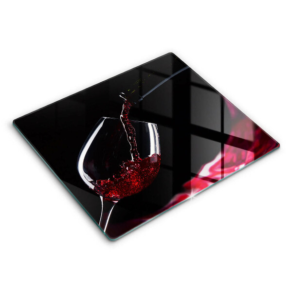 Skärbräda av glas Ett glas rött vin