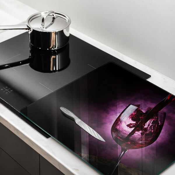 Skärbräda av glas Ett glas vin