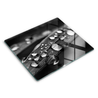 Skärbräda av glas Daggdroppar på löv