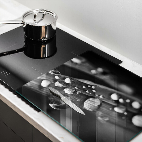 Skärbräda av glas Daggdroppar på löv