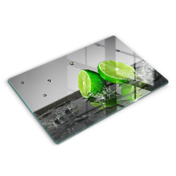 Skärbräda glas modern Saftiga lime och vatten