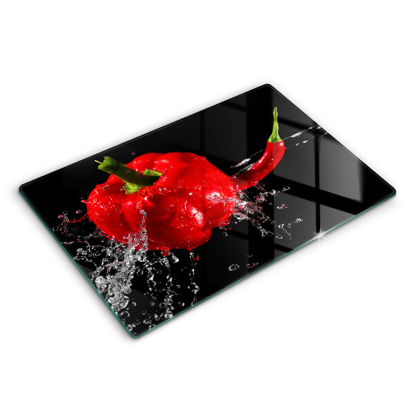 Skärbräda glas modern Röd paprika i vatten