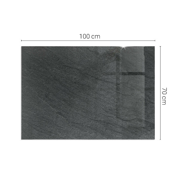 Rektangulär glasskiva framför öppen spis Stenytans struktur